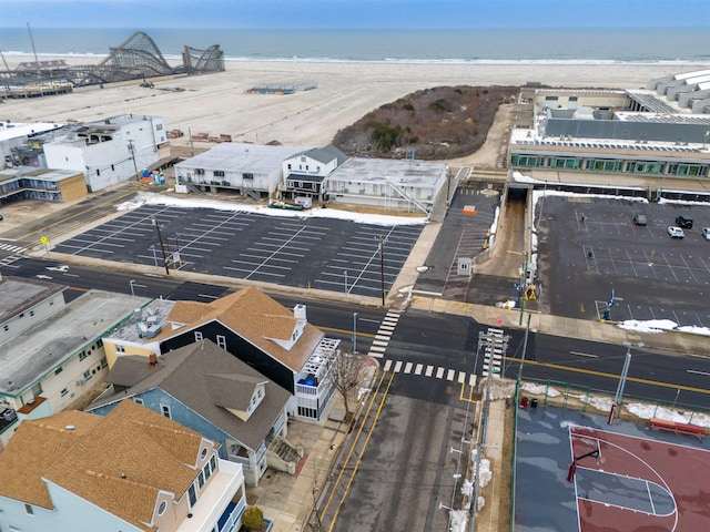 drone / aerial view featuring a water view and a view of the beach