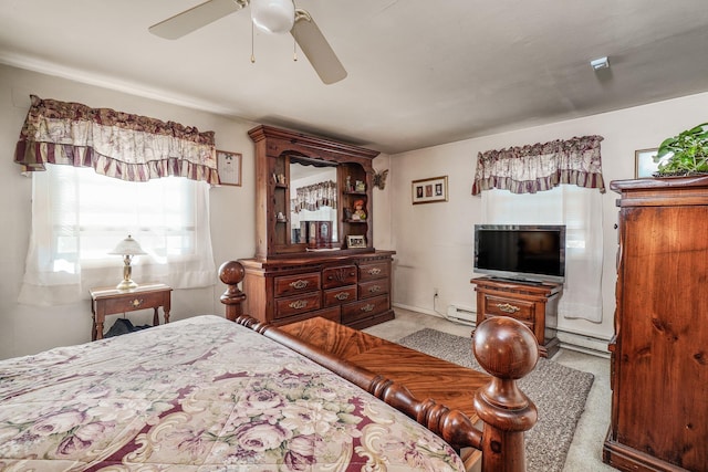 carpeted bedroom with baseboard heating and a ceiling fan