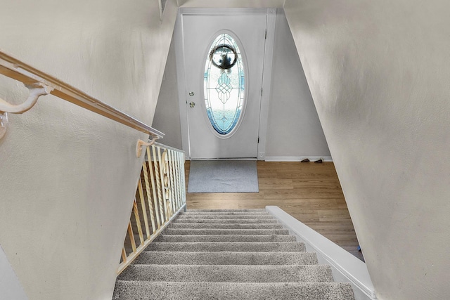 stairs featuring baseboards and wood finished floors