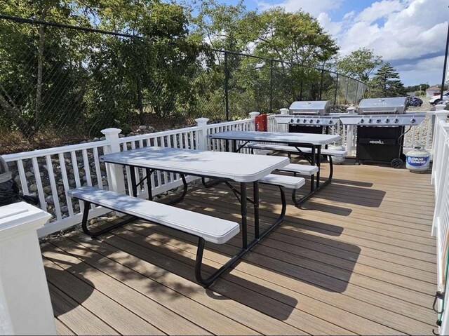 300 E Raleigh Ave Unit 106, Wildwood Crest, NJ 08260 - wooden deck with outdoor dining area and a grill