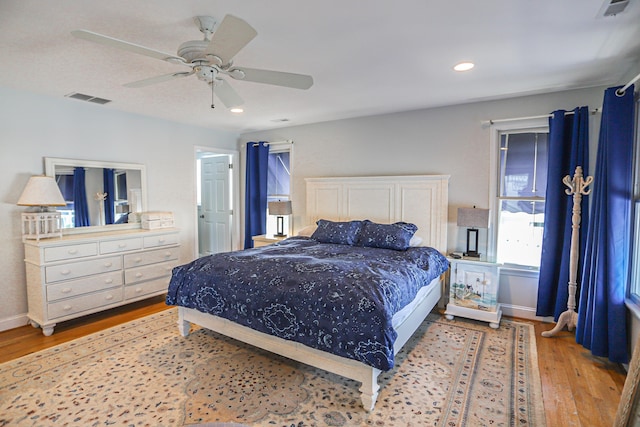 bedroom with ceiling fan and light wood-type flooring