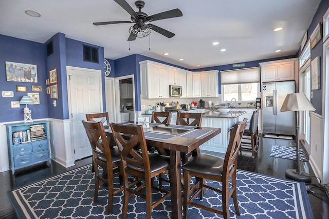 dining space with ceiling fan and dark hardwood / wood-style flooring