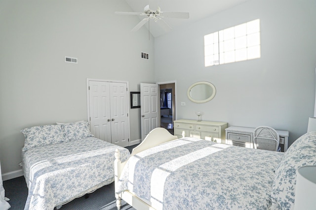 bedroom featuring ceiling fan, a closet, and high vaulted ceiling