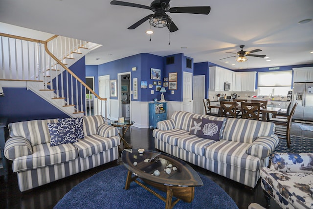 living room featuring ceiling fan and wood-type flooring