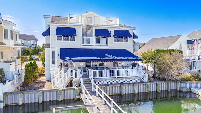 rear view of property with a balcony and a deck