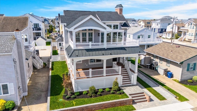 283 85th St, Stone Harbor, NJ 08247 - rear view of house with a residential view, stairway, a chimney, a shingled roof, and metal roof