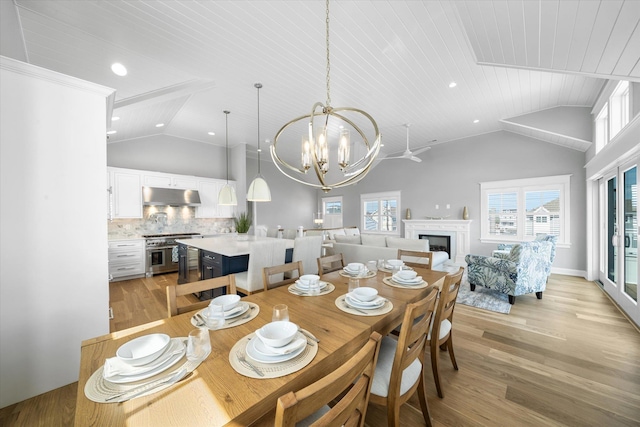 283 85th St, Stone Harbor, NJ 08247 - dining room with light wood-type flooring, a chandelier, wood ceiling, high vaulted ceiling, and a fireplace