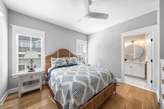283 85th St, Stone Harbor, NJ 08247 - bedroom featuring light wood-style floors, baseboards, ensuite bath, a sink, and ceiling fan