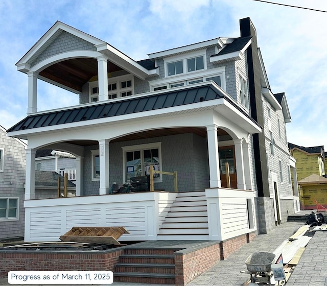 view of front of property featuring metal roof, a porch, and a standing seam roof