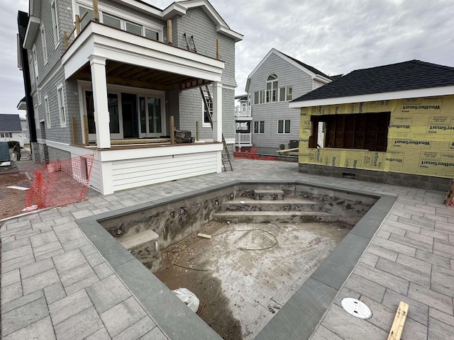 back of house featuring a patio area and a fire pit