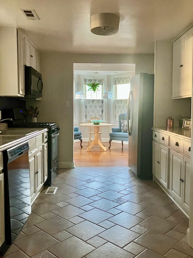 25 Shore Rd, Somers Point, NJ 08244 - kitchen with black appliances and white cabinetry