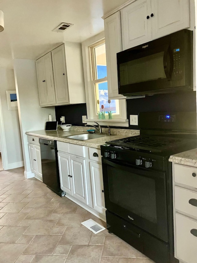 25 Shore Rd, Somers Point, NJ 08244 - kitchen with black appliances and white cabinets