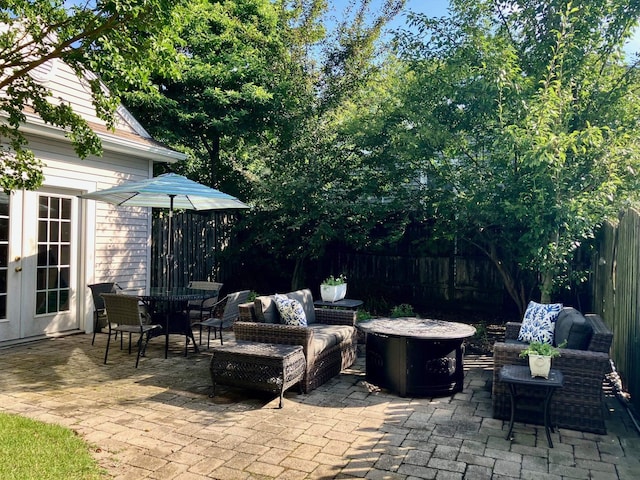 25 Shore Rd, Somers Point, NJ 08244 - fenced backyard featuring french doors, a patio area, an outdoor living space with a fire pit, and outdoor dining space