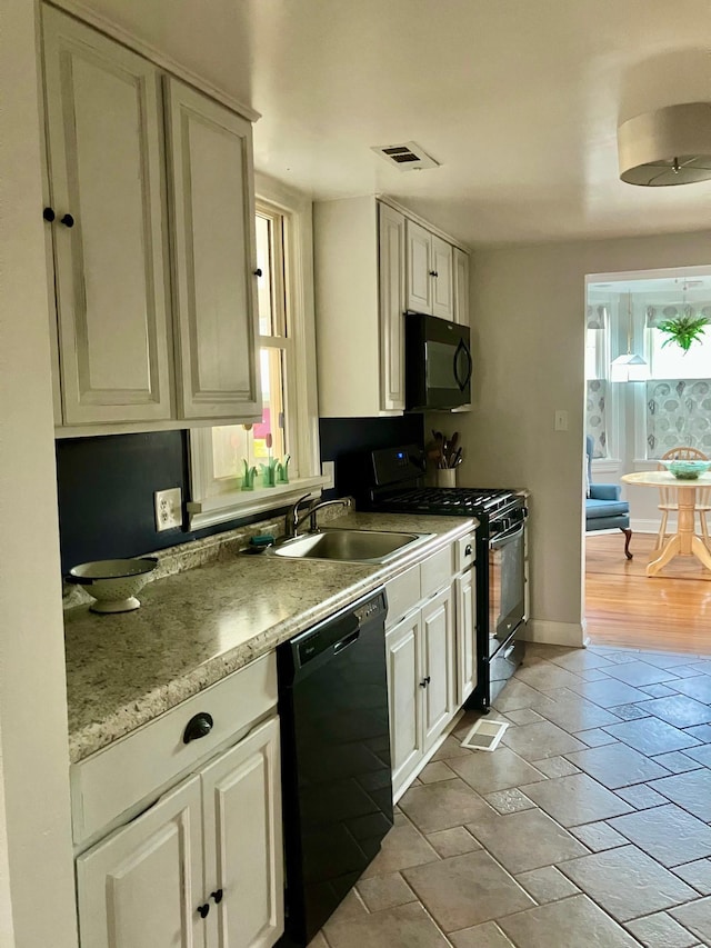 25 Shore Rd, Somers Point, NJ 08244 - kitchen with black appliances, light countertops, and white cabinetry