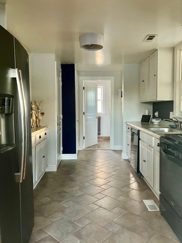 25 Shore Rd, Somers Point, NJ 08244 - kitchen featuring stainless steel fridge, dishwashing machine, white cabinetry, stove, and light countertops