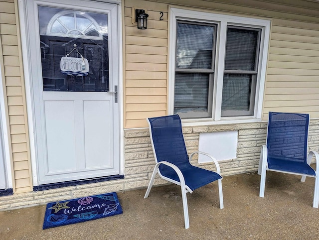 property entrance with stone siding