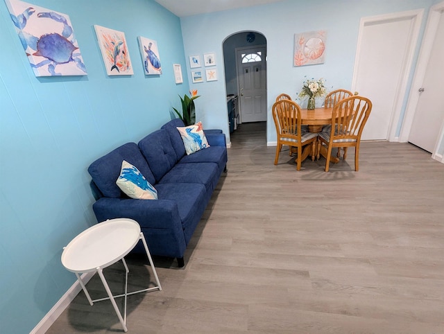 living room with baseboards and light wood-type flooring