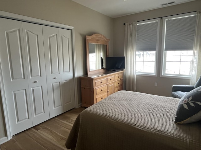 bedroom featuring wood finished floors and a closet