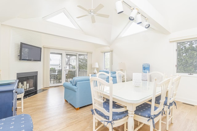 7889 Sunset Dr N, Unit North, Avalon, NJ 08202 - dining area featuring a ceiling fan, light wood-type flooring, healthy amount of natural light, vaulted ceiling, and a fireplace