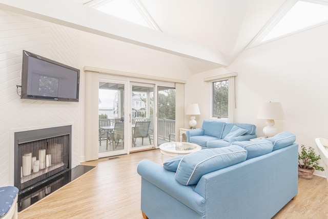 7889 Sunset Dr N, Unit North, Avalon, NJ 08202 - living room with wood finished floors, high vaulted ceiling, and a fireplace