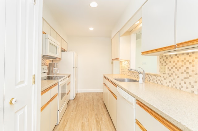 7889 Sunset Dr N, Unit North, Avalon, NJ 08202 - kitchen with white appliances, a sink, light wood finished floors, recessed lighting, and tasteful backsplash