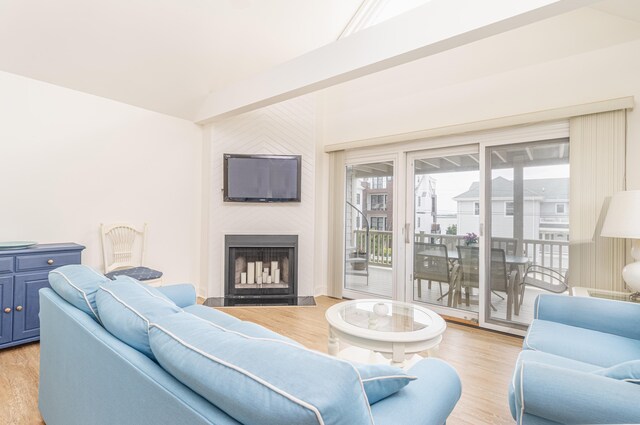7889 Sunset Dr N, Unit North, Avalon, NJ 08202 - living room with vaulted ceiling, light wood-style floors, and a large fireplace