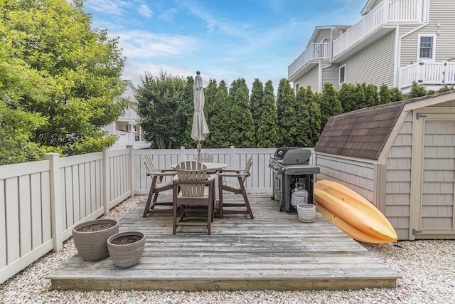 7889 Sunset Dr N, Unit North, Avalon, NJ 08202 - wooden terrace featuring area for grilling, outdoor dining space, and an outdoor structure