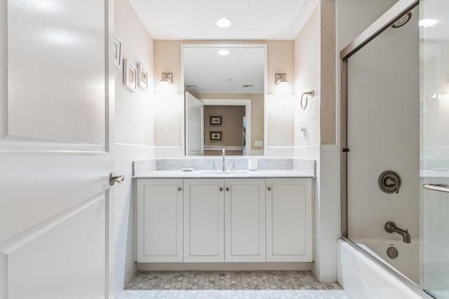 bathroom featuring enclosed tub / shower combo and vanity