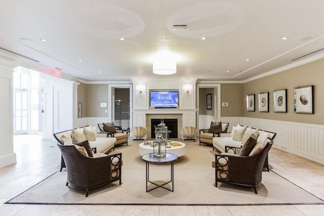 living area with recessed lighting, wainscoting, ornamental molding, a fireplace, and light tile patterned flooring
