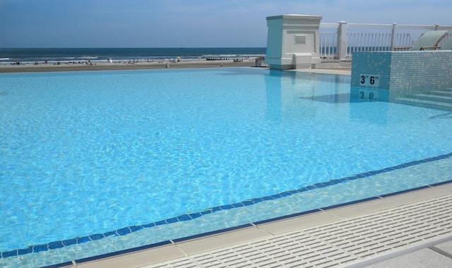 view of pool with a water view