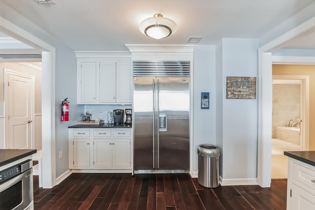 kitchen with white cabinets and appliances with stainless steel finishes