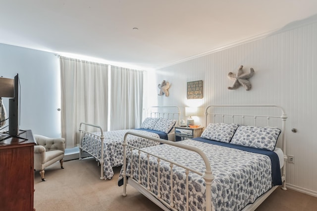 carpeted bedroom with ornamental molding