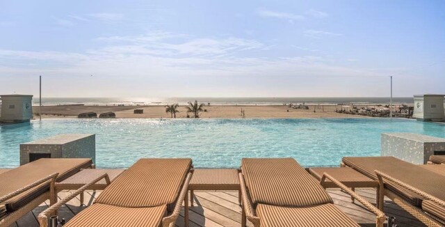 view of pool featuring a water view