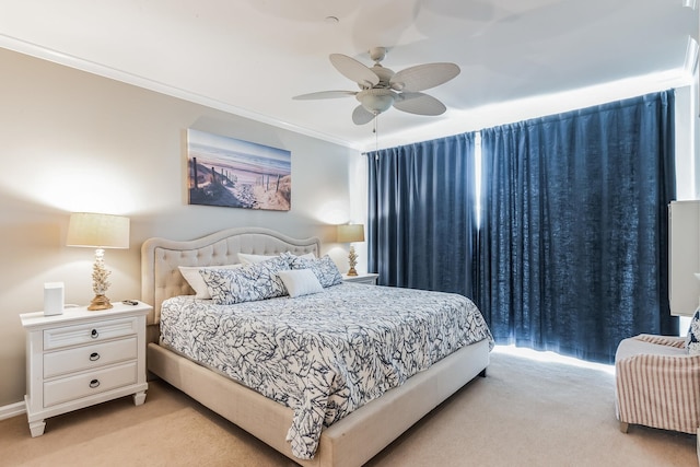 carpeted bedroom with ceiling fan and crown molding