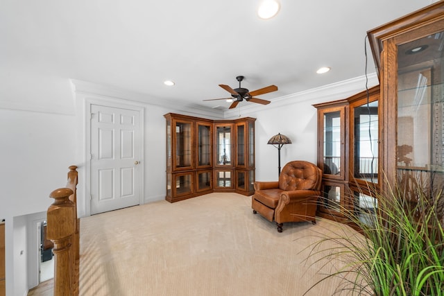 sitting room featuring light carpet, ceiling fan, crown molding, and recessed lighting