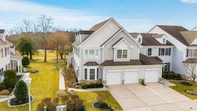 view of front of property with stone siding, concrete driveway, a front lawn, and a garage