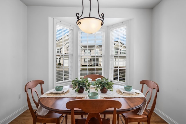 dining room with plenty of natural light, baseboards, and wood finished floors