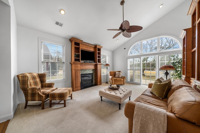 living area with ceiling fan, recessed lighting, a large fireplace, light colored carpet, and visible vents