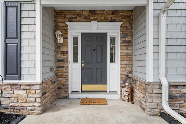 doorway to property featuring stone siding