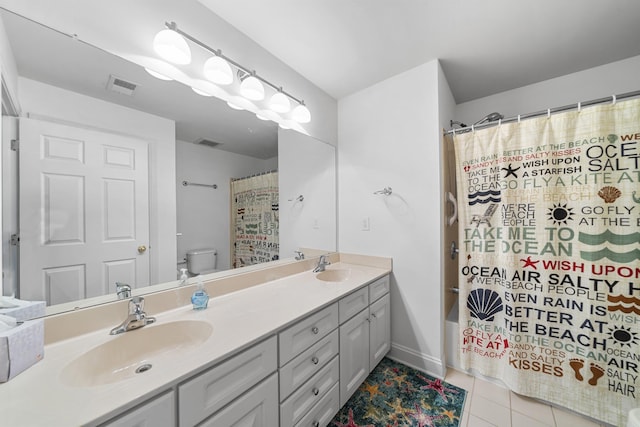 full bathroom with double vanity, tile patterned flooring, visible vents, and a sink