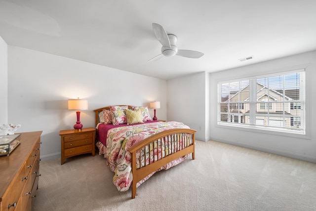 carpeted bedroom featuring baseboards, visible vents, and ceiling fan