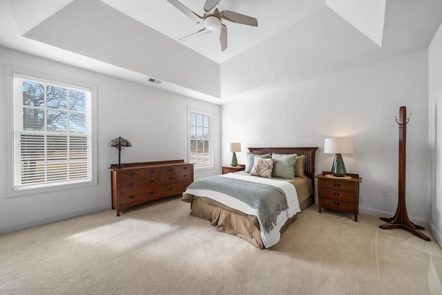 bedroom with baseboards, a ceiling fan, visible vents, and light colored carpet