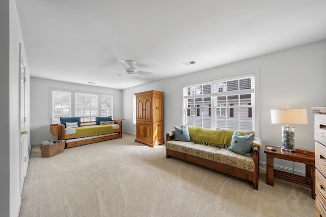 living room with light carpet, baseboards, and a ceiling fan