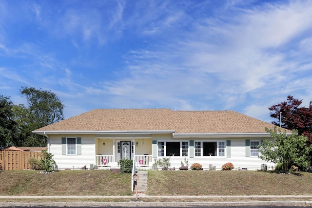 ranch-style house featuring a front lawn and a porch