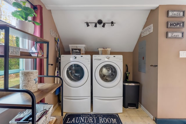 washroom with electric panel and washer and clothes dryer