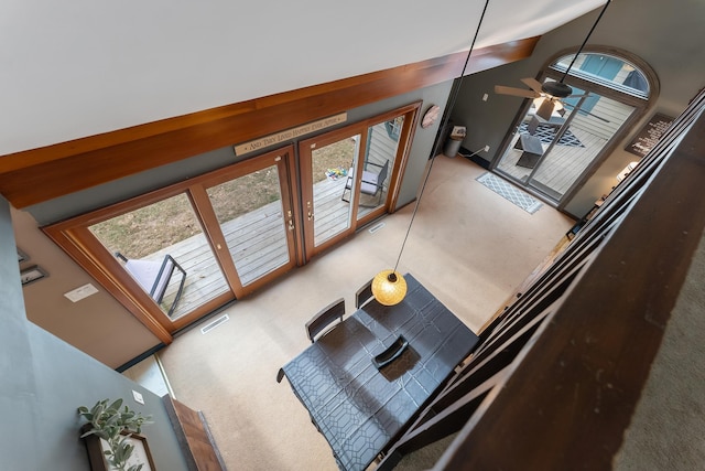 living room featuring carpet flooring, ceiling fan, and vaulted ceiling