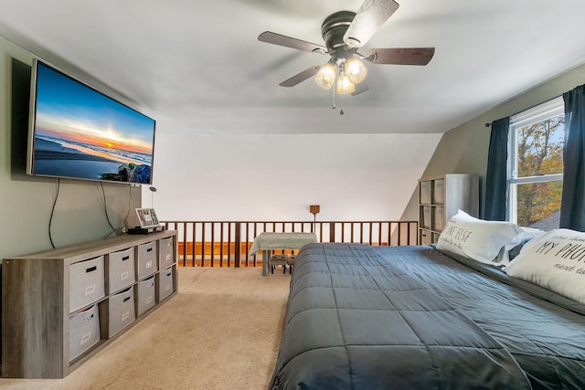 carpeted bedroom featuring ceiling fan and vaulted ceiling