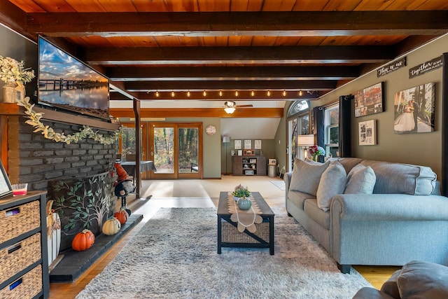 living room featuring vaulted ceiling with beams, track lighting, ceiling fan, and wooden ceiling