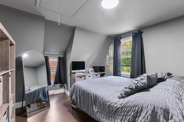 bedroom with dark wood-type flooring and vaulted ceiling