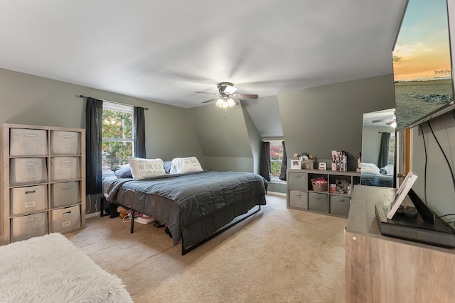 carpeted bedroom with ceiling fan and lofted ceiling